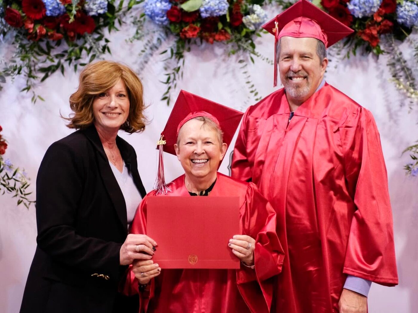 Pastor Kimberley presenting a graduate her certificate at Bible Institute commencement